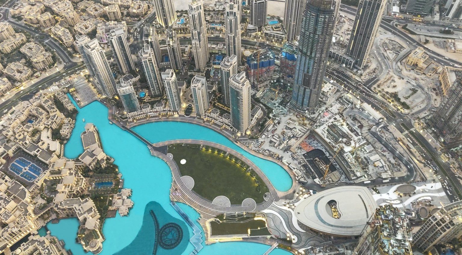 Aerial view of downtown Dubai showing surrounding buildings and turquoise water features