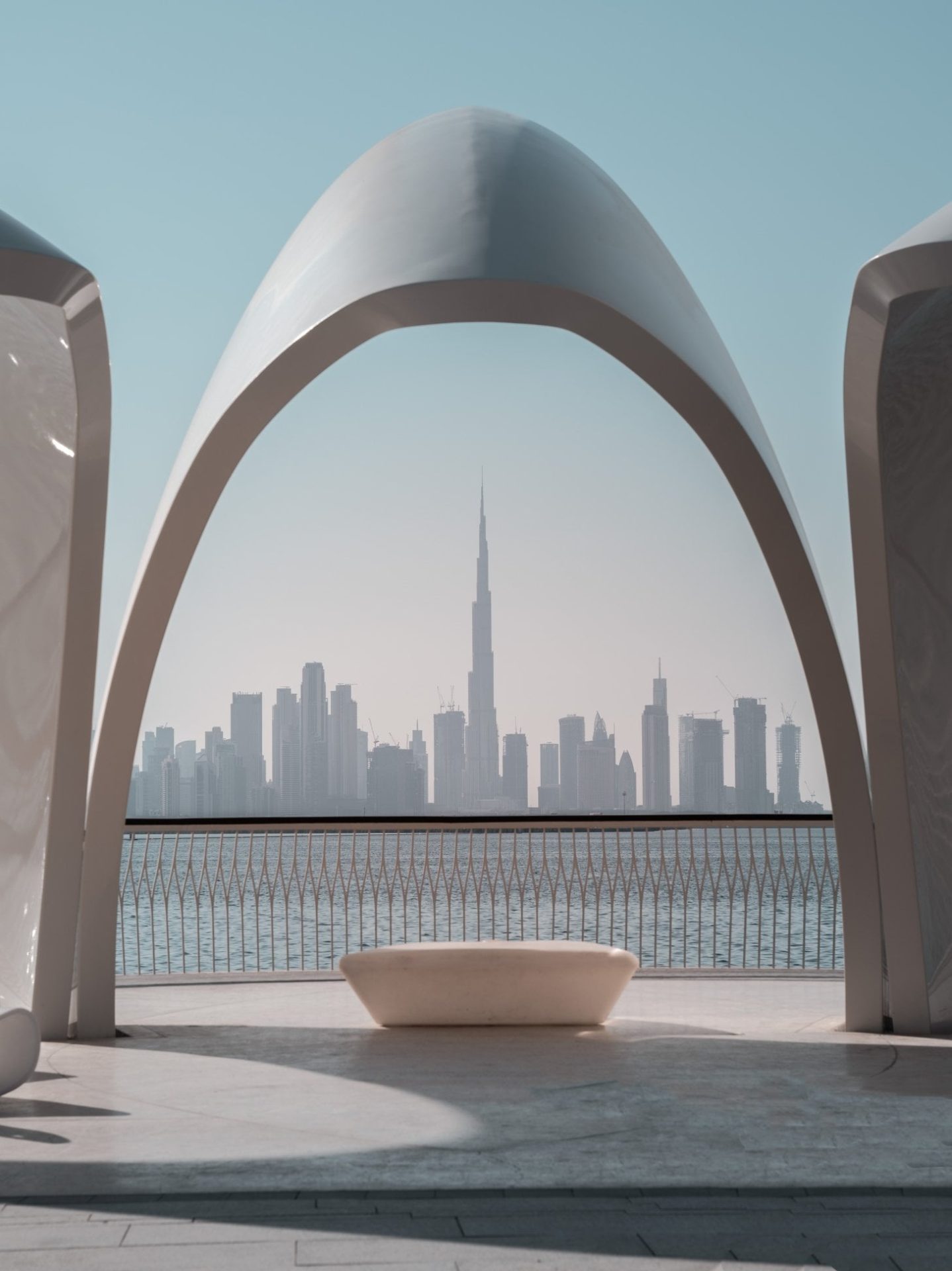 View of Burj Khalifa framed by modern architectural arches in Dubai