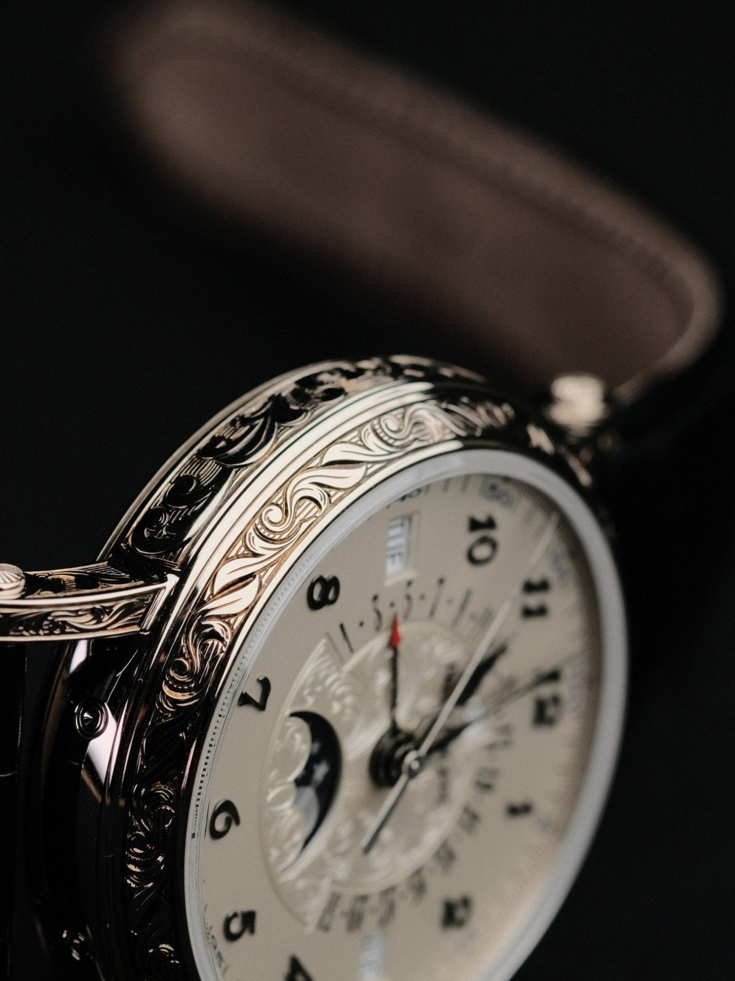Close-up of an ornate vintage watch dial showcasing fine horological craftsmanship