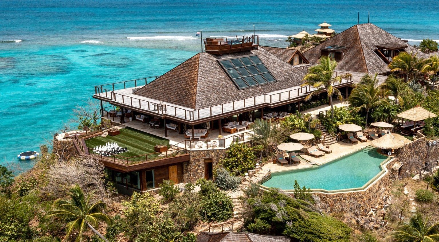 Aerial view of Necker Island’s main estate with luxury villas and cliffside pool