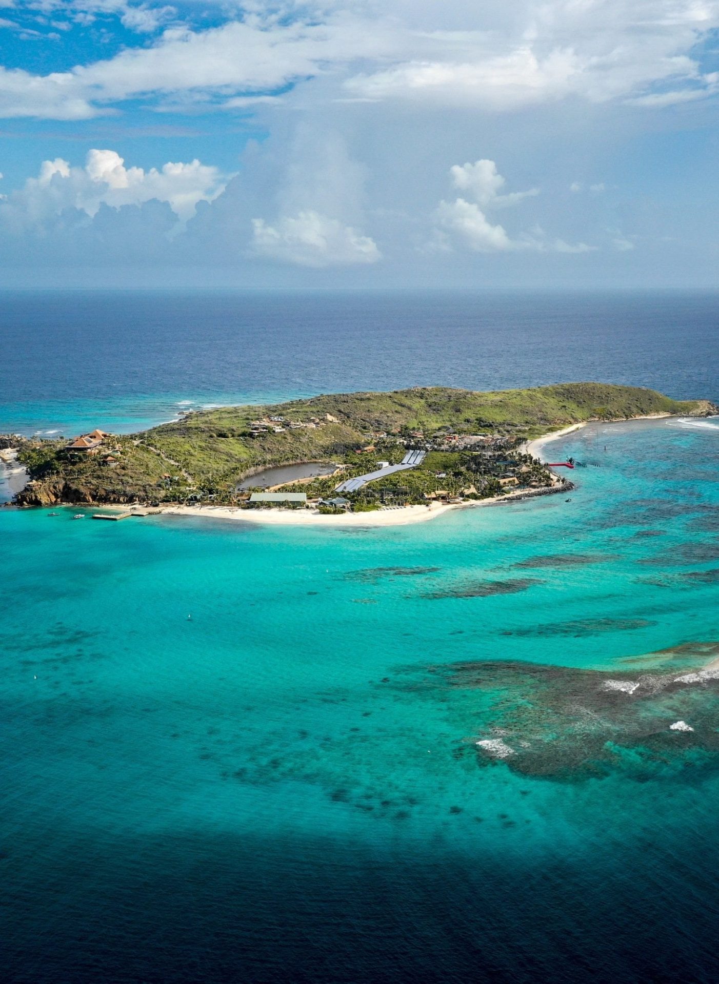 Aerial view of Necker Island surrounded by crystal-clear Caribbean waters