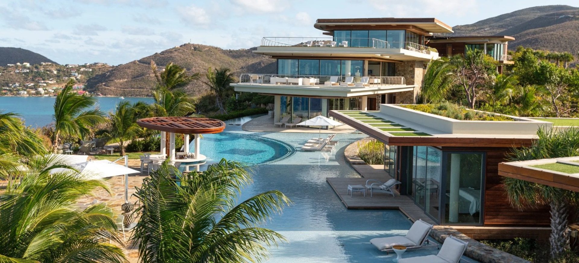 Luxury villas on Necker Island with lagoon-style pool and tropical landscaping