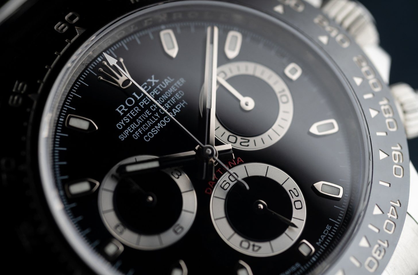 Close-up of the Rolex Daytona black dial highlighting the chronograph sub-dials and tachymeter bezel