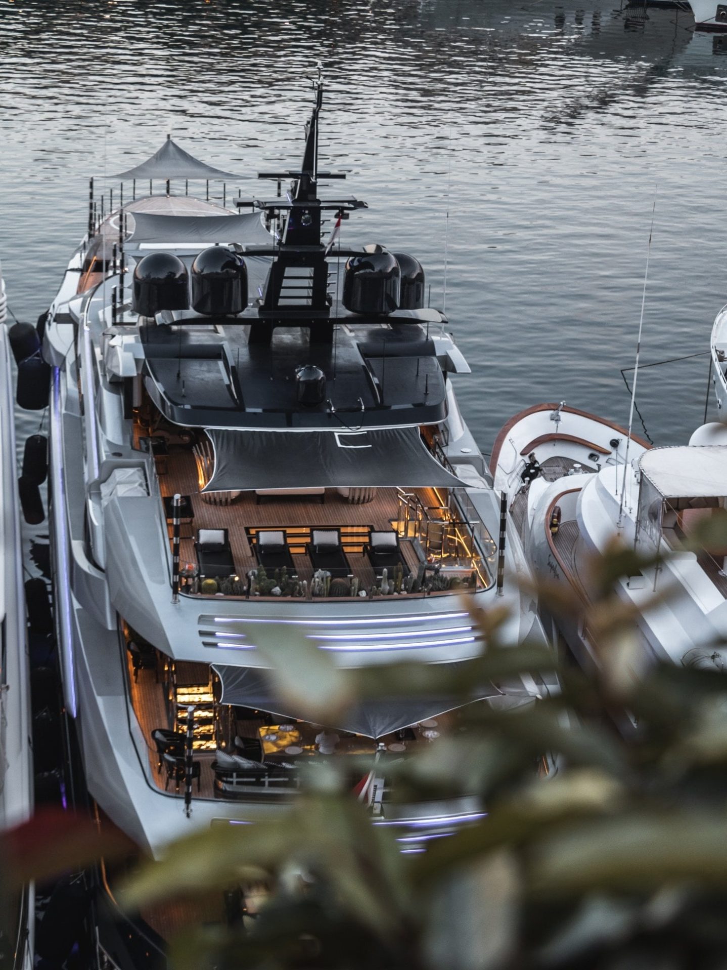 Luxury superyacht docked in Monaco marina during golden hour