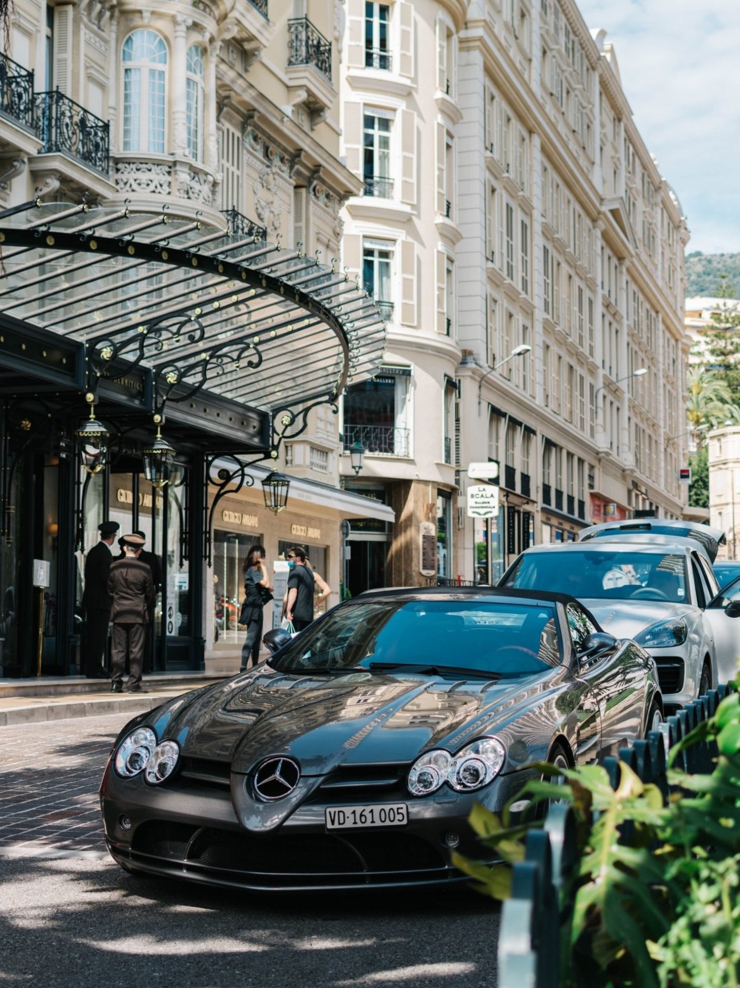 Classic Monte Carlo street scene with luxury cars outside a grand hotel