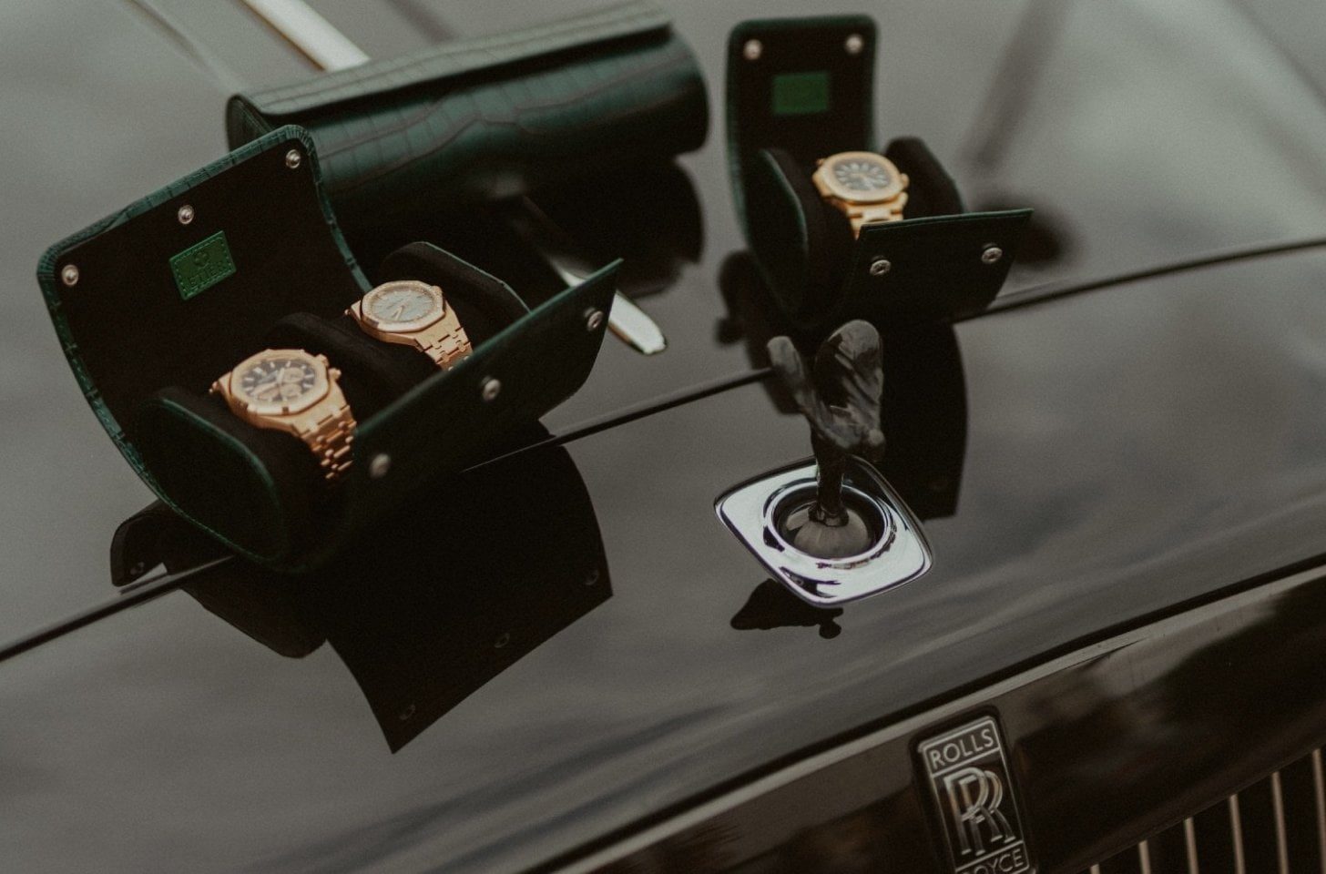 Crocodile leather watch rolls holding luxury timepieces on a prestige car