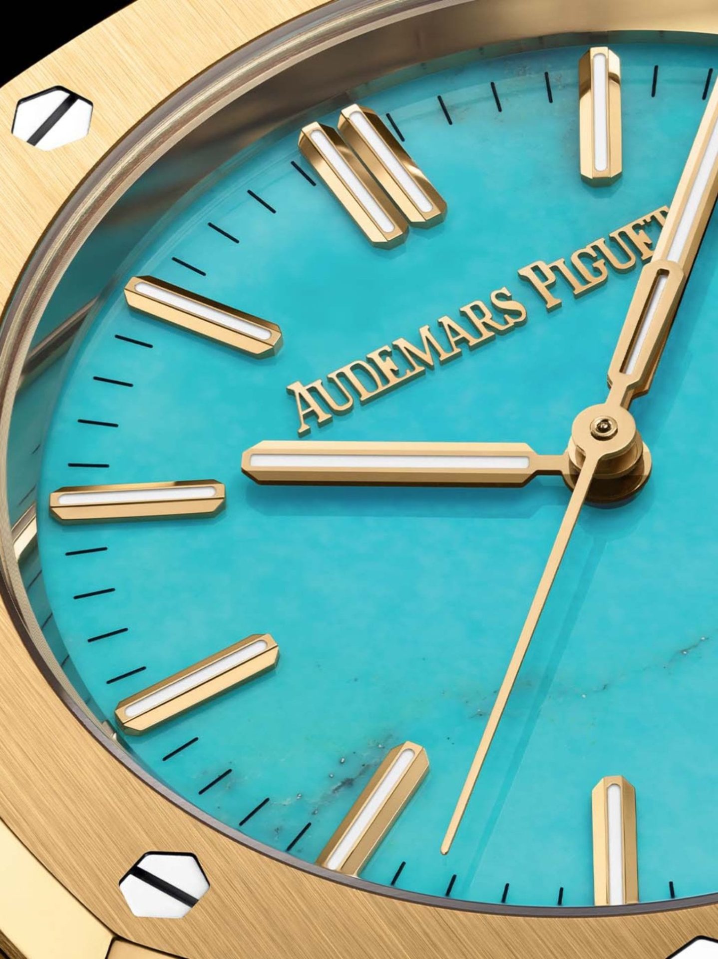 Close-up of the Audemars Piguet Royal Oak dial featuring a turquoise face, gold hour markers and refined detailing