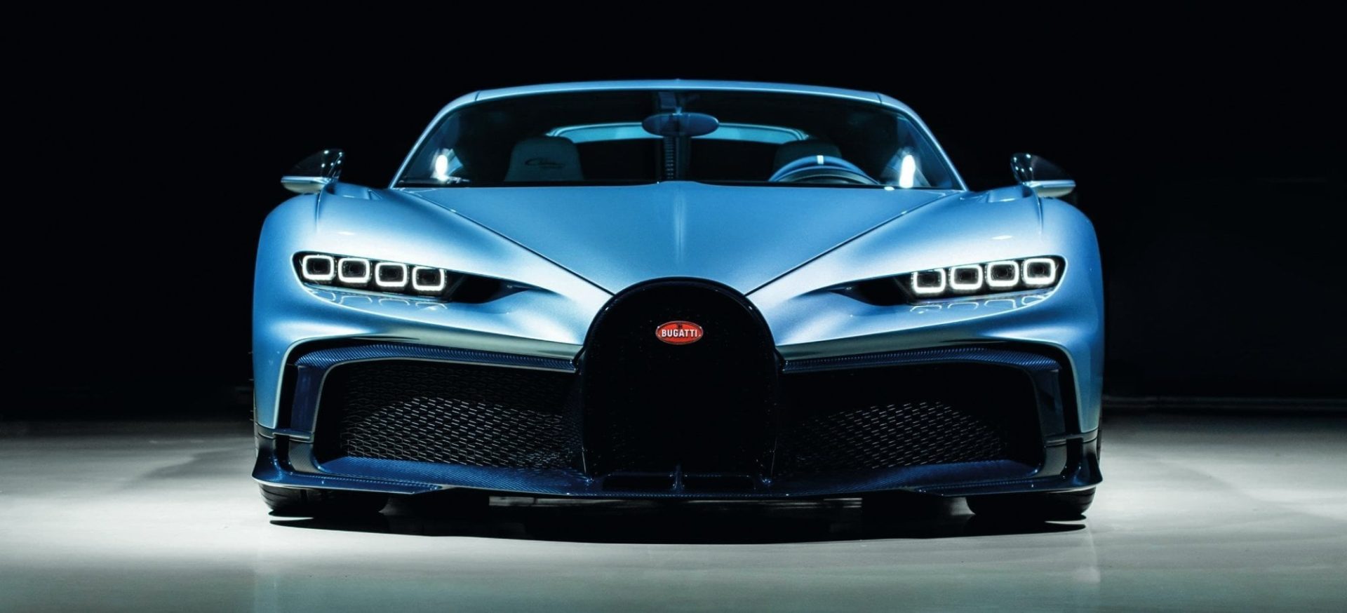Front view of a blue Bugatti sports car showing grille design and distinctive headlights