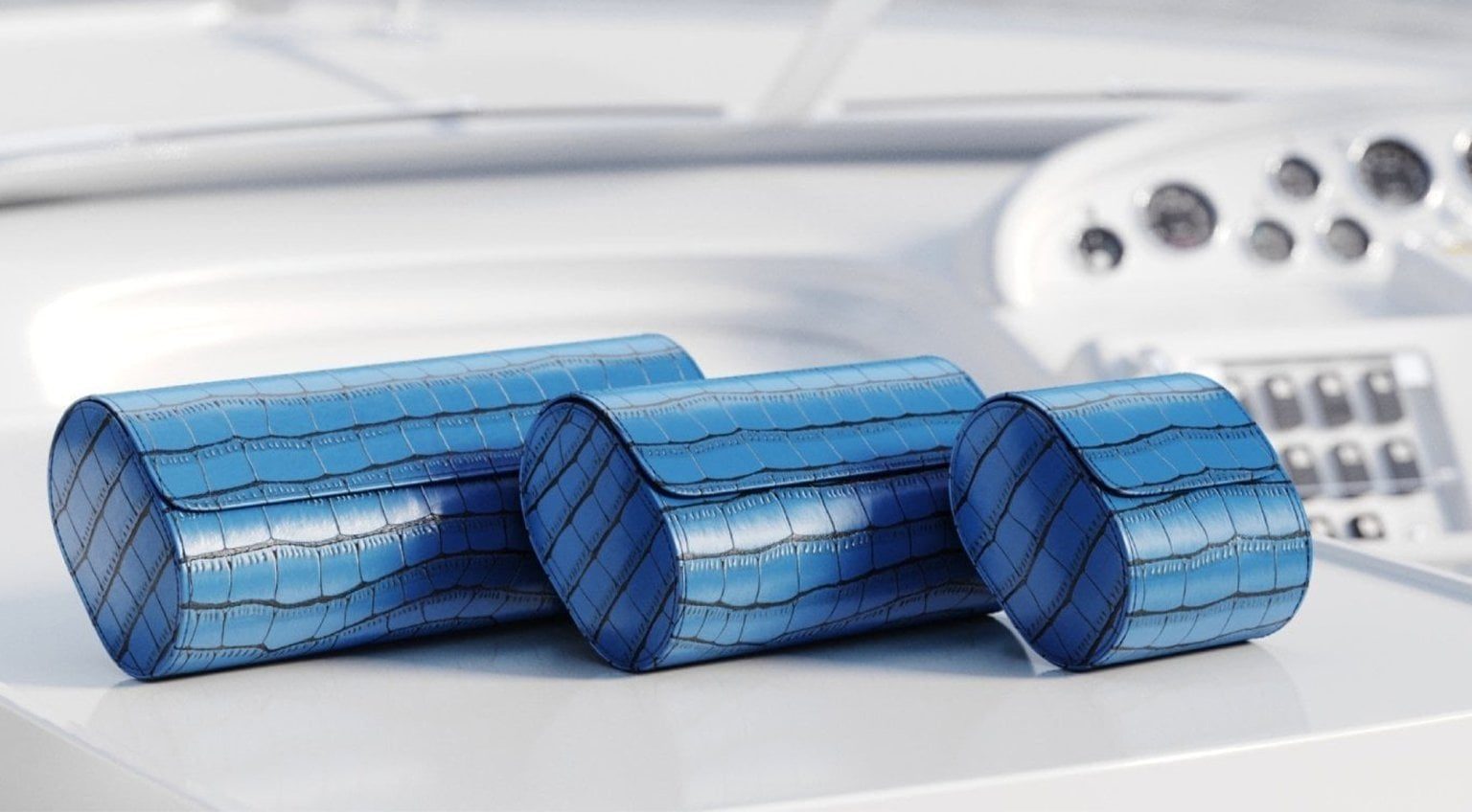 A selection of blue crocodile leather watch rolls designed to protect and store watches safely while travelling