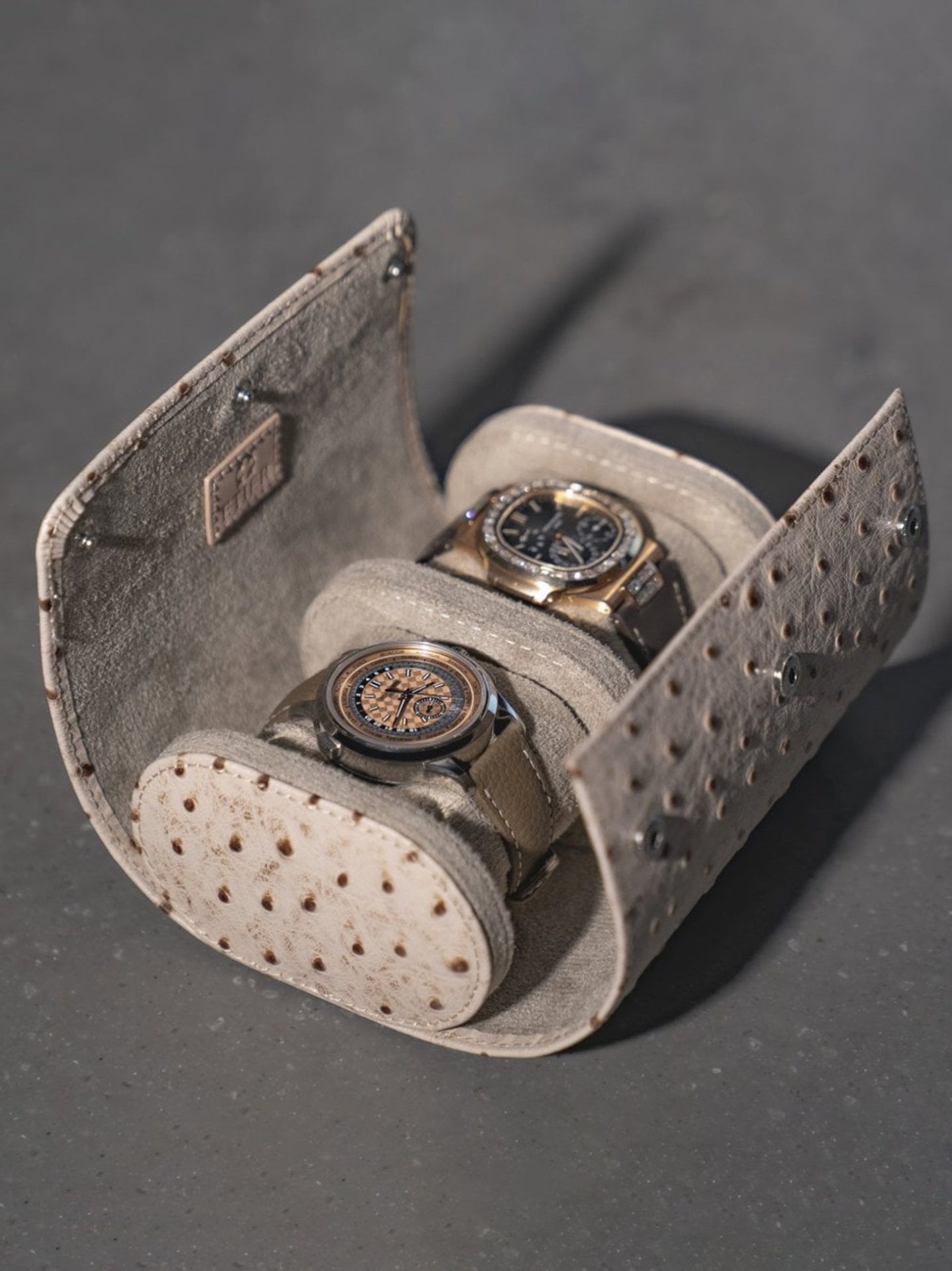 Leather watch roll with soft interior cushioning, offering protection against scratches and impact during travel