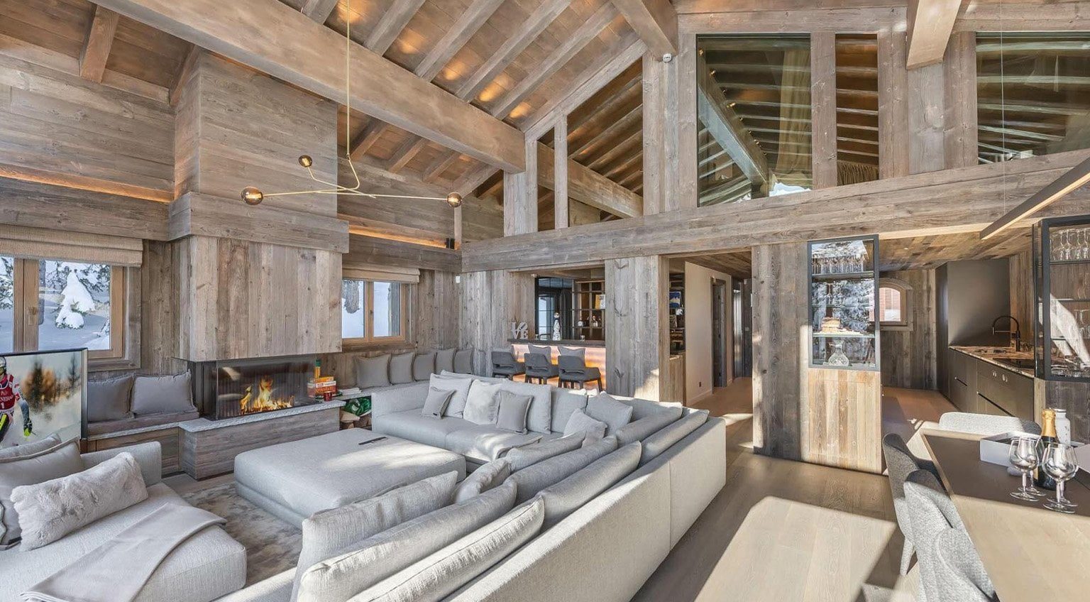 Elegant alpine chalet interior with natural wood beams and fireplace