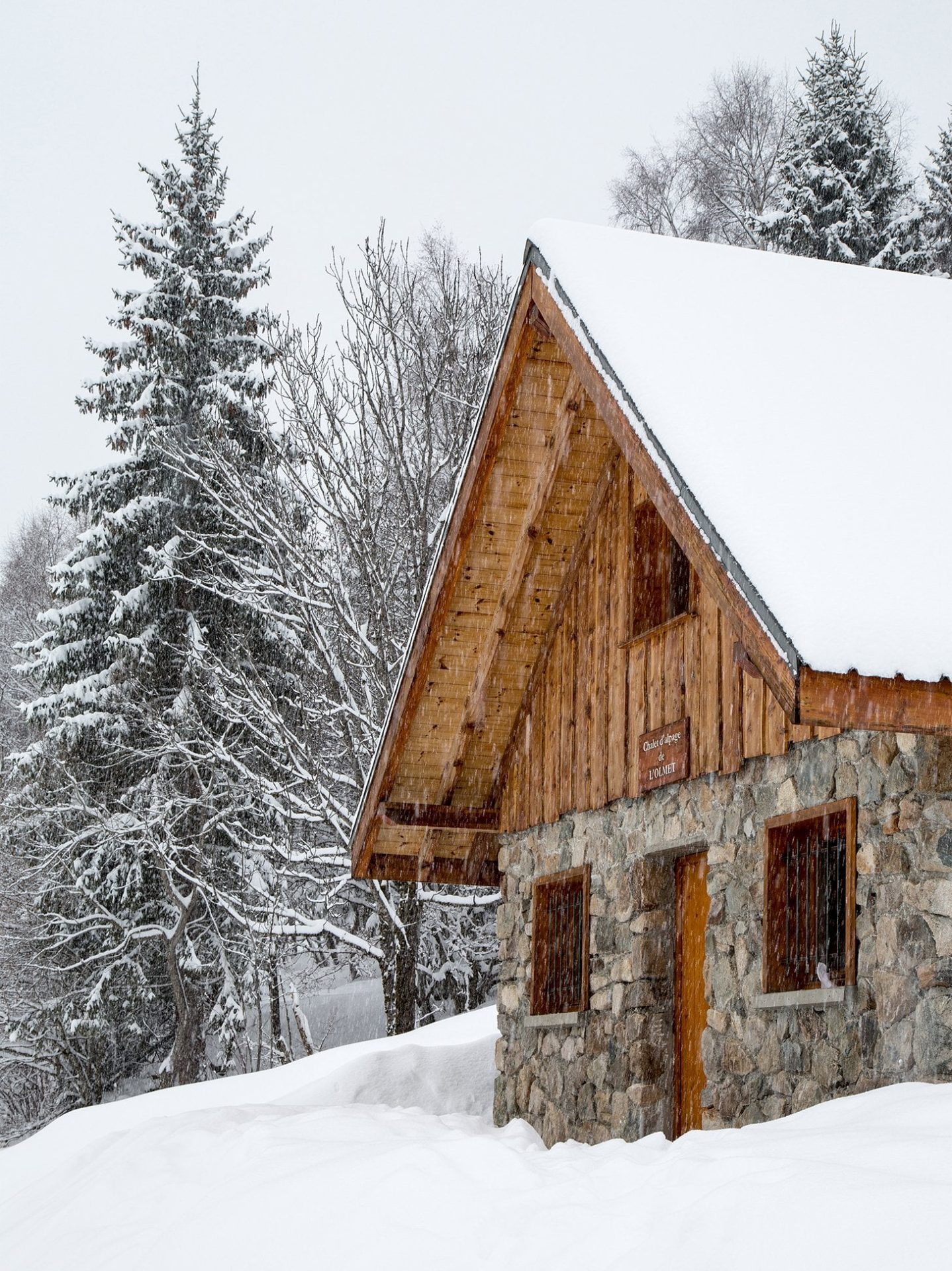 Traditional wooden mountain cabin set in snowy Courchevel forest