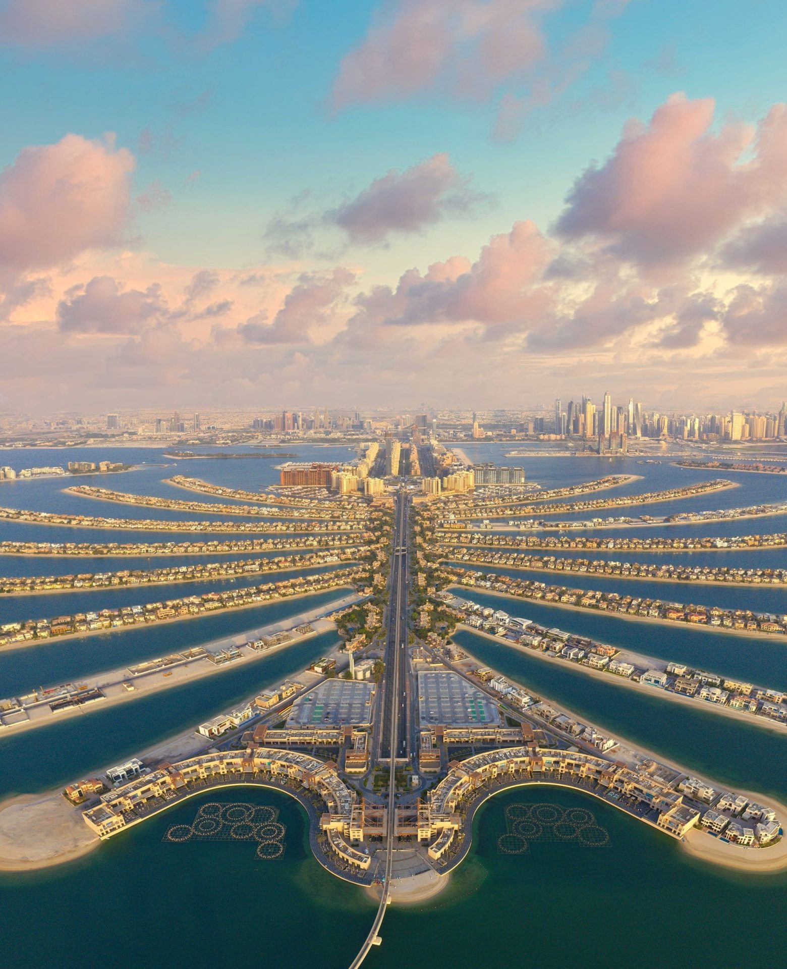 Aerial view of The Palm Dubai showcasing its iconic palm-shaped design against the Arabian Gulf at sunset