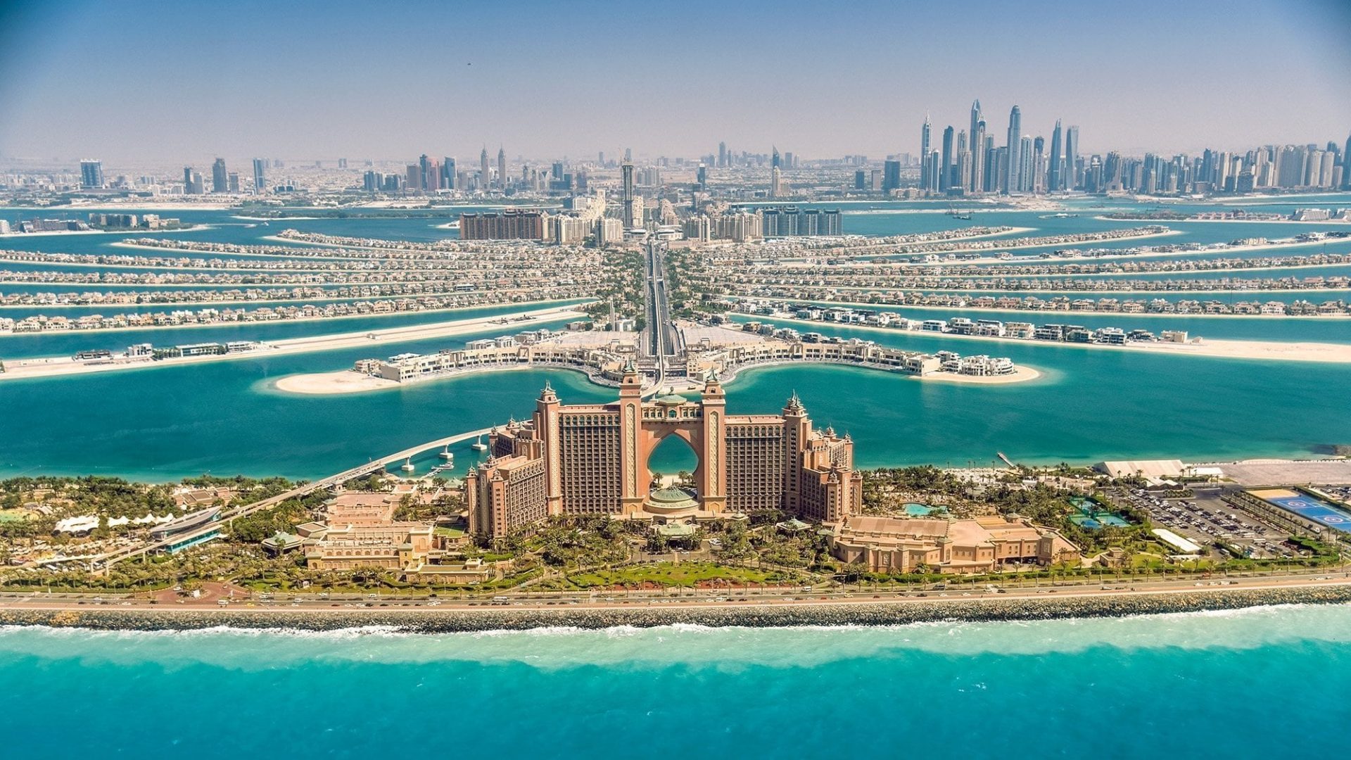 Aerial view of The Palm Jumeirah Dubai featuring Atlantis The Palm, palm-shaped islands and the Dubai skyline