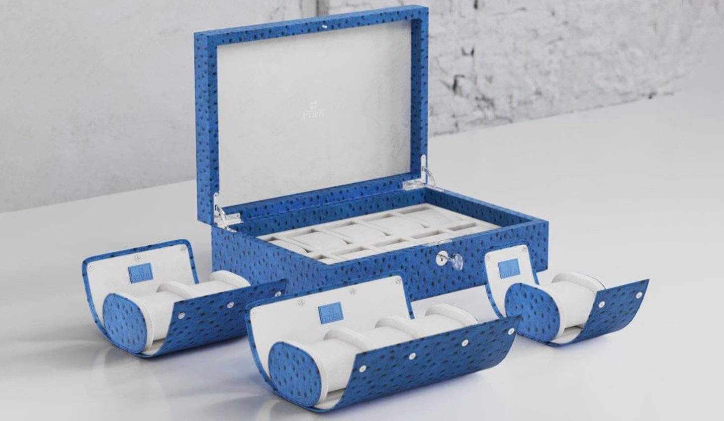 Ostrich leather collection featuring a luxury watch case and matching watch rolls in a vibrant blue finish